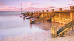 Edinburgh's Portobello Beach with wooden groynes at sunset