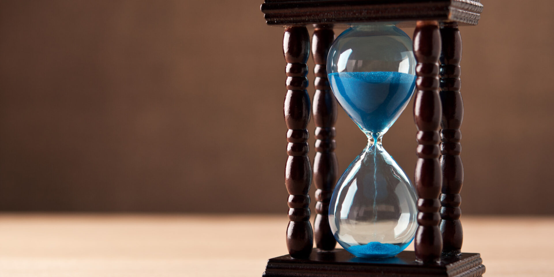 Glass egg timer with blue sand