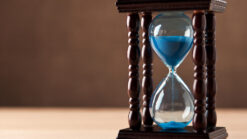 Glass egg timer with blue sand
