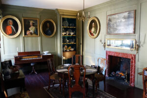 18th century drawing room with green wood panelled walls