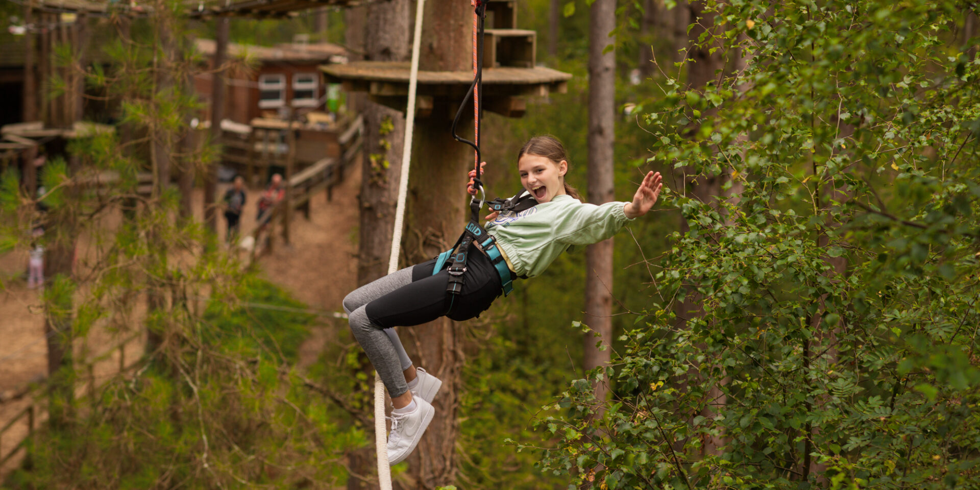 Child on a zip wire through the forest