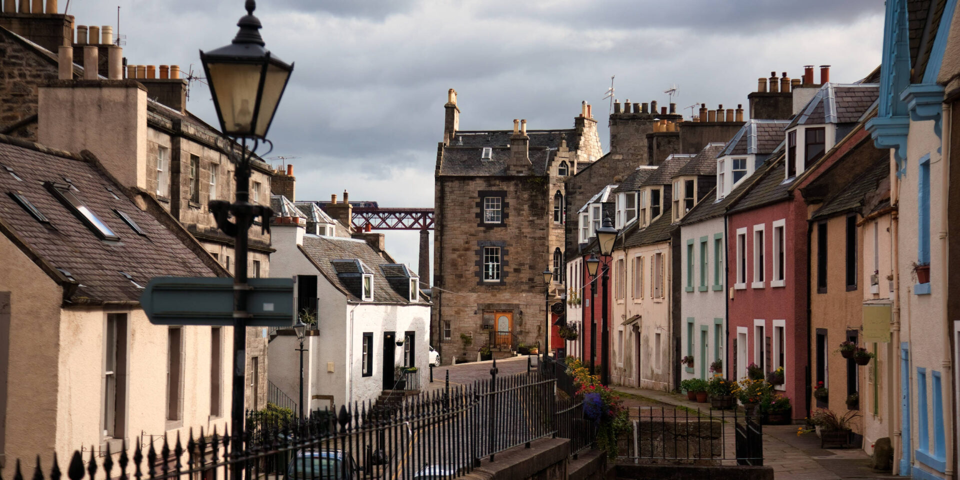 Colourful buildings in South Queensferry, with Forth Bridge in the background