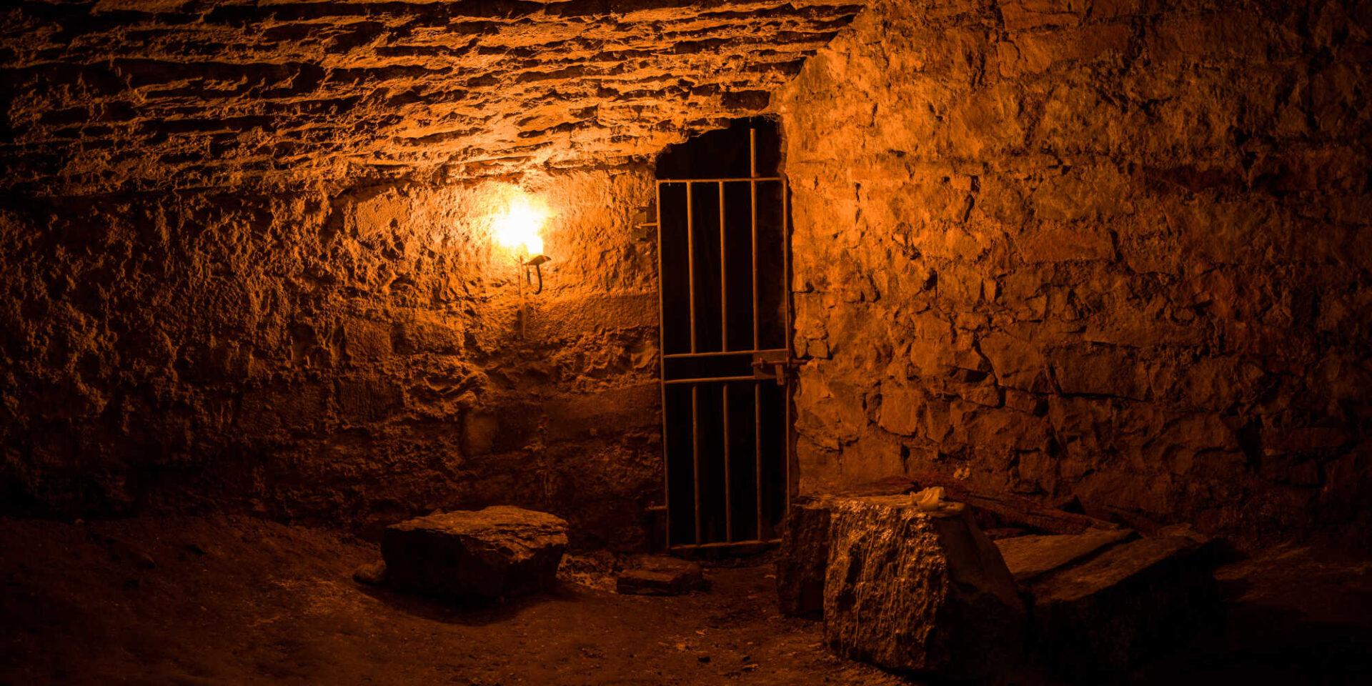 Scottish underground dungeon cells lit only by torchlight